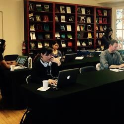 Students sitting at table with laptops, working with focus